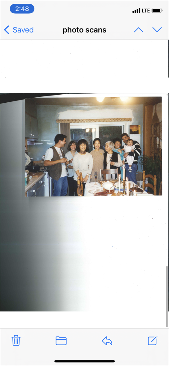 Families gather in a warm kitchen, sharing food and joyful moments while celebrating together.