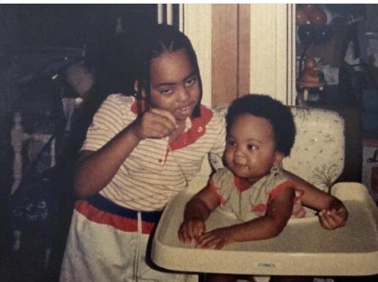 Two young children are having fun together at snack time in a vintage kitchen setting.