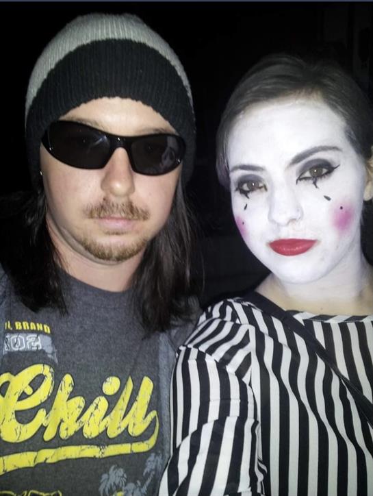 Costumed individuals enjoy a festive atmosphere during a Halloween event at night.