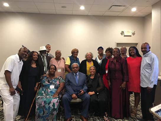 A group gathered to share stories and celebrate their heritage in a welcoming space.