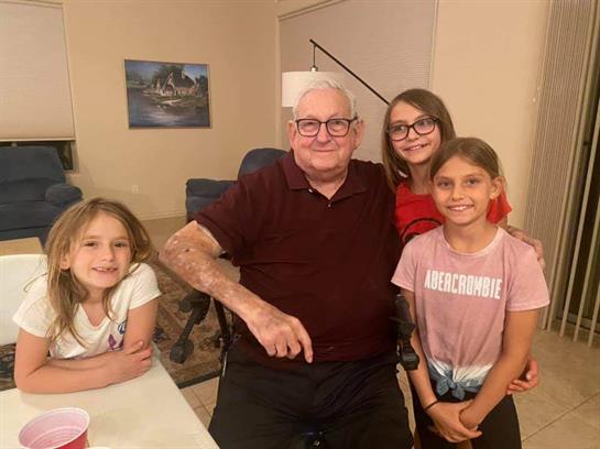 Children enjoying quality time with their grandfather in a warm and inviting home atmosphere.