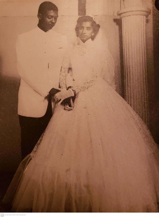 A couple in formal attire embodies timeless romance and joy on their wedding day.