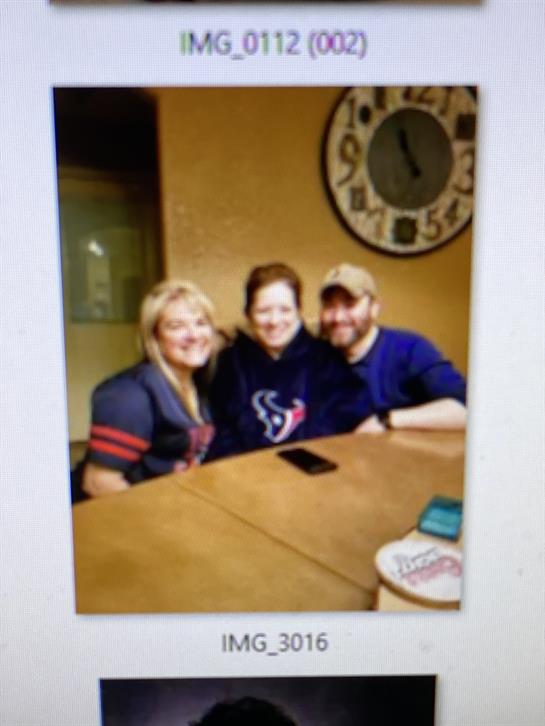 Three friends gather in a cozy room, smiling and sharing a joyful moment during their time together.