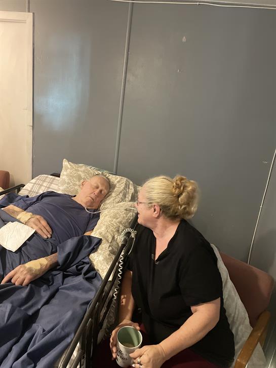 A caregiver shares a heartfelt moment with a patient in a hospital setting.