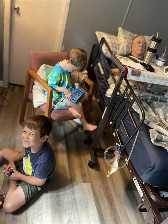 Two young children entertain themselves in a hospital room, bringing a sense of joy to their visit.