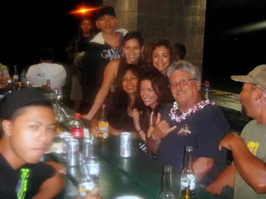 Friends gather at a bar, enjoying drinks and laughter while celebrating a joyful occasion.