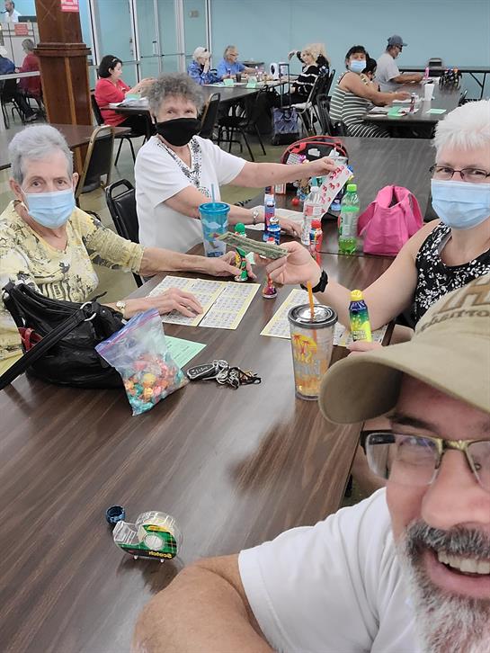 Seniors engage in a fun bingo game, sharing laughter and camaraderie in their community center.