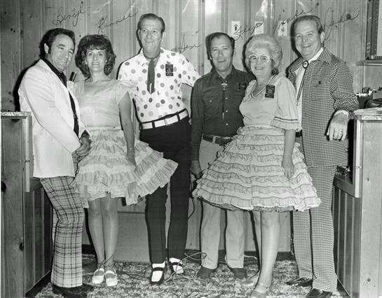 Group of people dressed in vintage clothing, enjoying a lively dance party together.