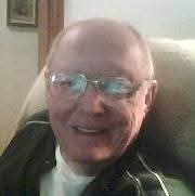 A man wearing glasses and smiling