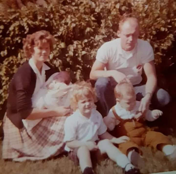 A family sitting on the grass