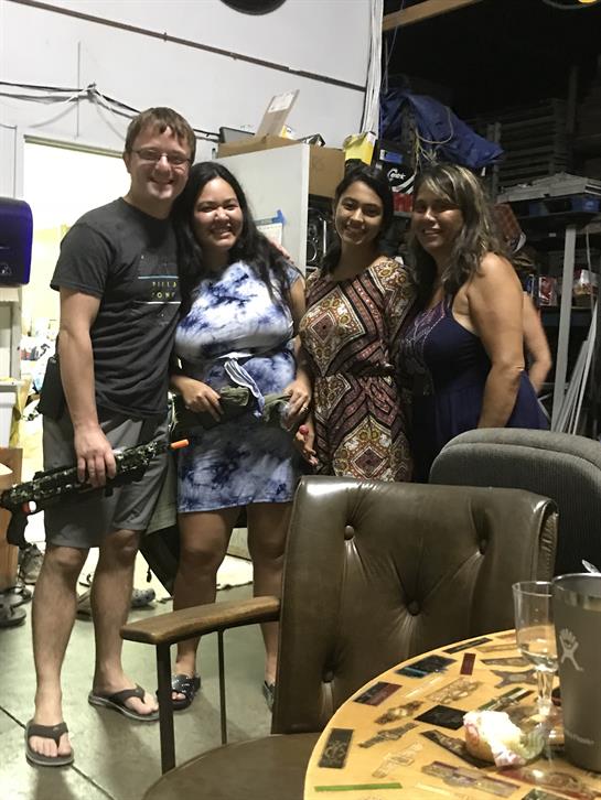 Four friends gather in a creative studio, sharing smiles and laughter on a summer evening.