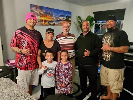 A cheerful family comes together in a cozy living room, enjoying each other's company and warmth.