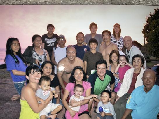 A large family gathering unites generations for a joyful celebration in a cozy setting.