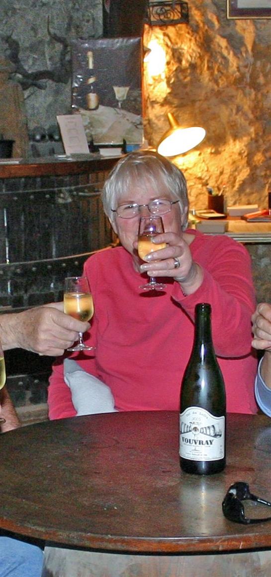 Lively group enjoys drinks together, sharing laughter and companionship in a warm atmosphere.