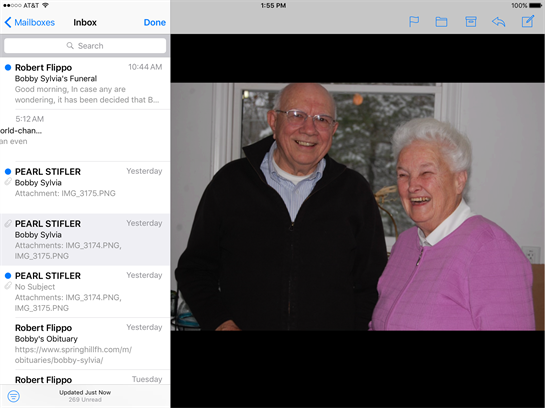 A cheerful couple enjoys each other's company in a warmly lit living room, sharing laughter.