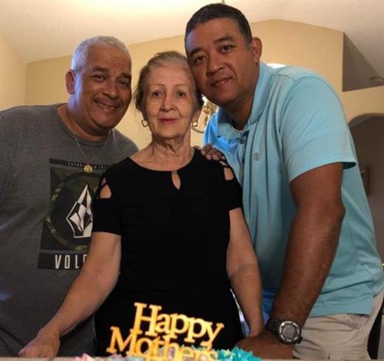 Three family members enjoy Mother's Day, sharing cake, laughter, and heartfelt wishes.