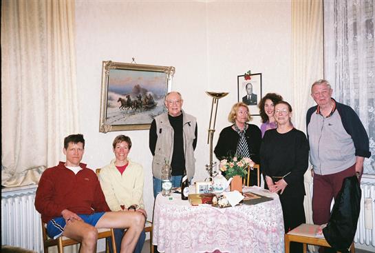 Friends and family share laughter and warmth in a cozy living room.