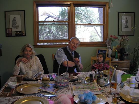 A cheerful family enjoys each other's company at a festive dining table decorated for winter.