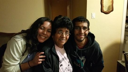 Three family members share a joyful moment together in their cozy home.