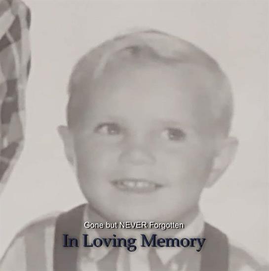 A young boy is shown with a big smile, honoring his memory and celebrating his life.