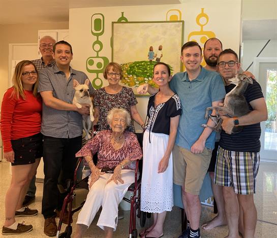 Group of family members and pets enjoy time together in a welcoming living room environment.