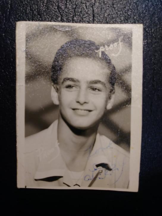 A happy young boy is captured in a close-up portrait, showcasing his cheerful expression.