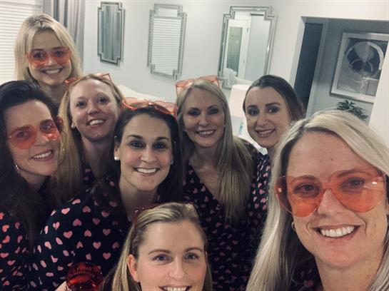 Friends celebrate joyfully in a stylish bathroom, sharing laughter and good times together.