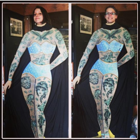 Models display detailed tattoo art during an event focused on body art and creativity.