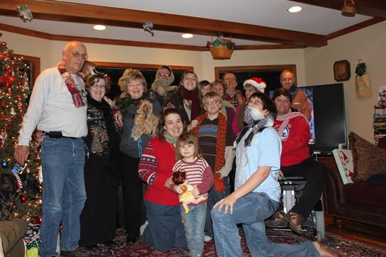 A big group of family and friends joyfully celebrates the holidays together.