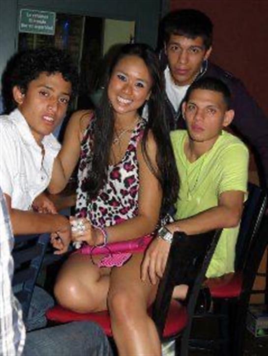 Group of friends poses together at a lively club, sharing smiles and enjoying their night out.