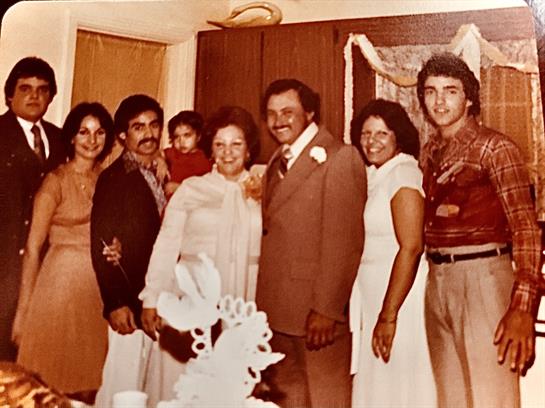 A joyful family gathering captures happy moments during a celebration in a warm, inviting room.