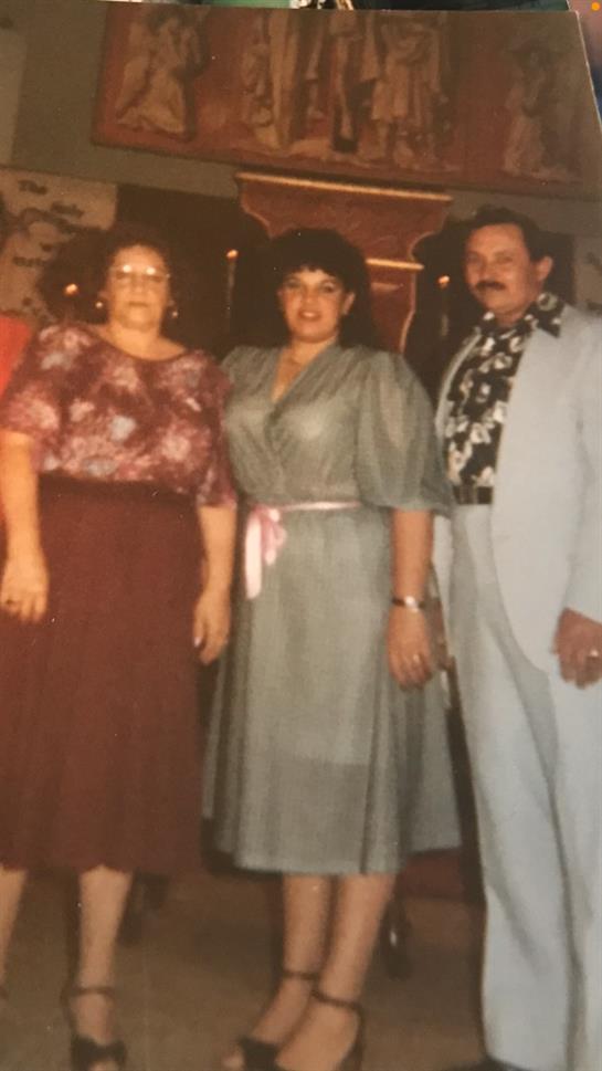 Friends gather for a celebration, wearing stylish outfits typical of the 1980s era.