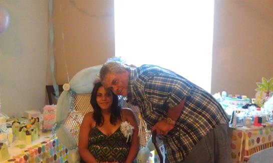 Two friends pose closely together in a welcoming living room during a joyful gathering.