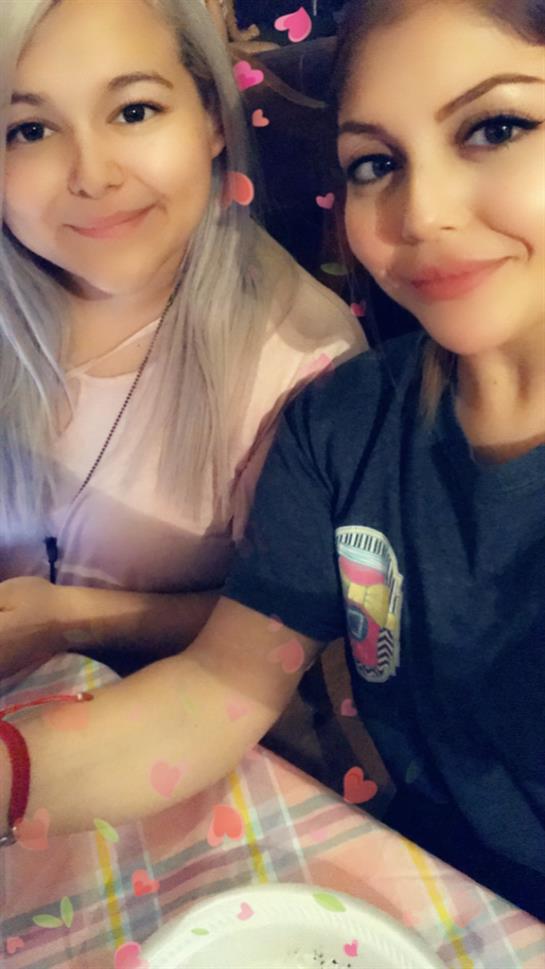 Friends relax at home, sharing snacks and enjoying each other's company during the evening.