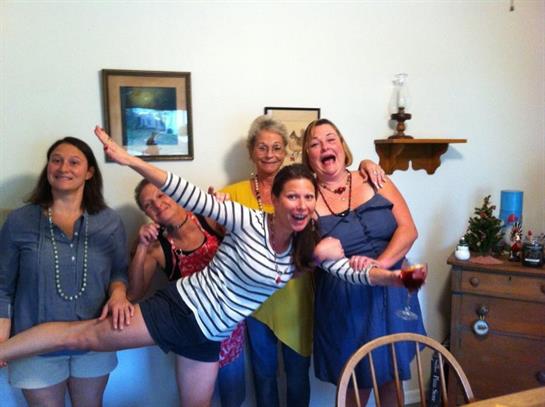 Friends gather in a cozy room, sharing laughter and joyful moments during a lively event.