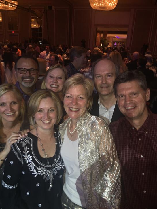 Friends gather together, smiling at a celebration filled with laughter and good vibes.