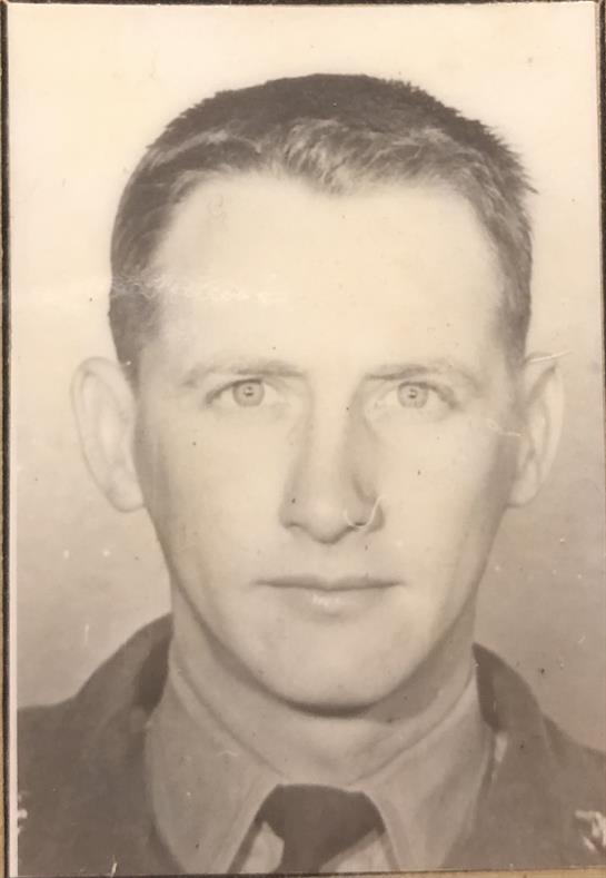 This portrait features a man with short hair and intense gaze, likely from the mid-1900s.