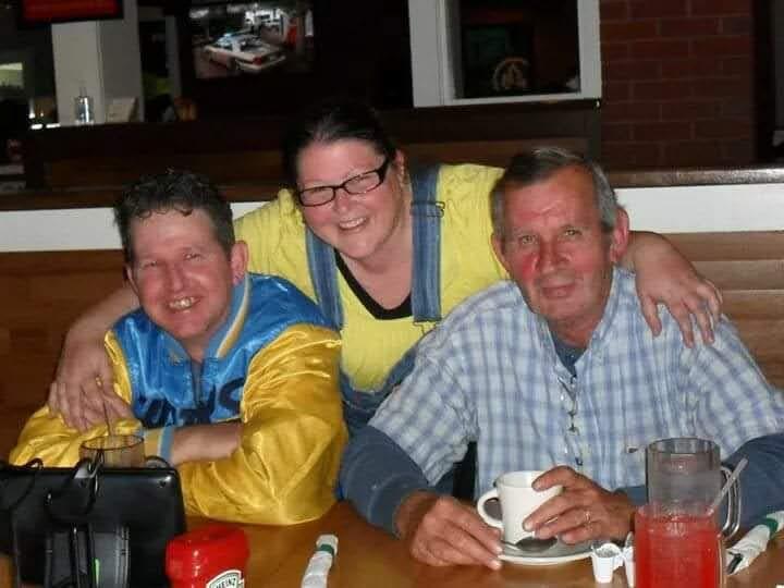 Three friends share a pleasant moment at a diner, engaging in conversation and laughter.