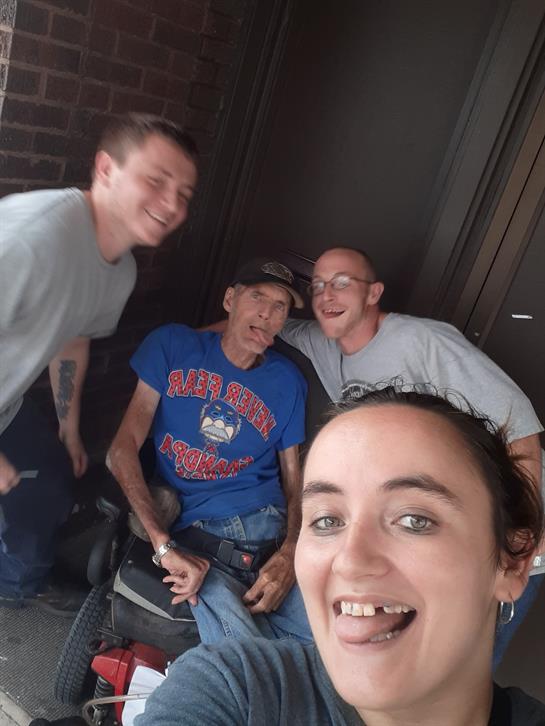 Friends pose happily together, smiling and laughing, creating joyful memories outdoors.