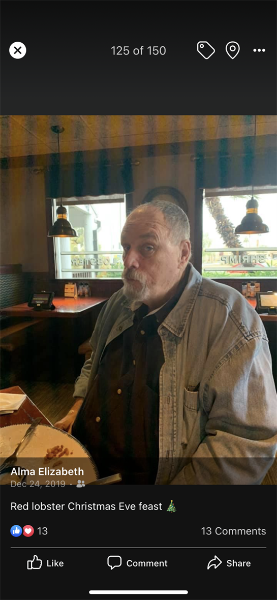 A mature man sits at a table, appearing contemplative while enjoying a meal in a relaxed eatery.