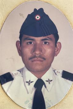 Close-up of a soldier in military uniform displaying a serious expression.