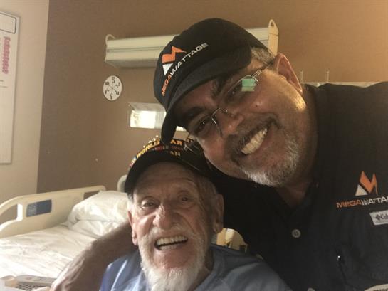 Two individuals share a heartfelt smile in a hospital room, highlighting their bond during a visit.