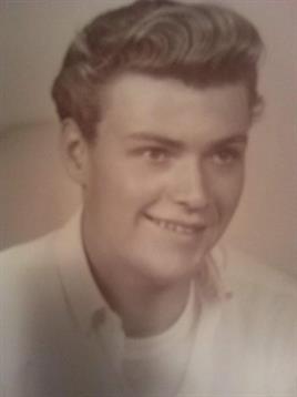 A cheerful young man poses with a friendly smile, showcasing a classic style from a bygone era.