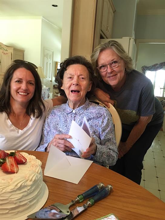 Family members celebrate a birthday, enjoying cake and creating happy memories together.