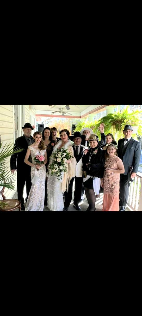 Friends and family gather in a lovely outdoor setting to celebrate a joyful wedding occasion.