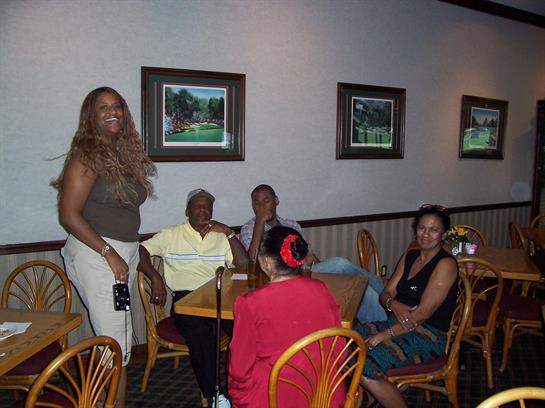 Friends enjoy a warm evening at a cafe, sharing stories and laughter, creating joyful memories.