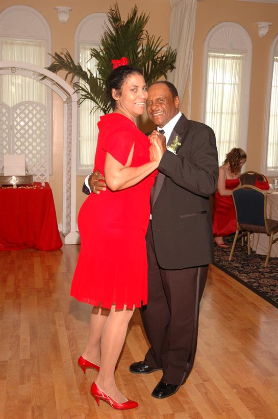 Guests enjoy a lively dance during a joyful celebration in an elegantly arranged venue.