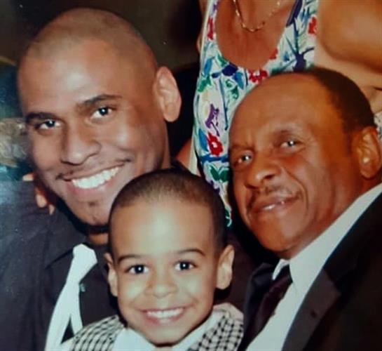 Three generations of family members celebrate together, sharing laughter and warmth during an event.