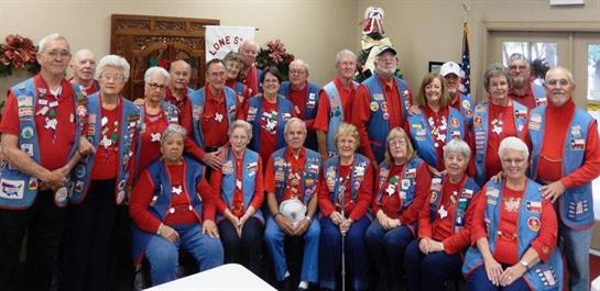 Seniors participate in a cheerful community gathering, dressed in matching red attire.