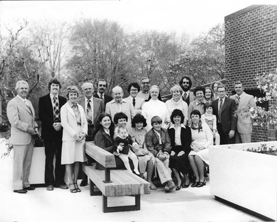 A group gathers in a sunny park, celebrating friendship and family bonds.